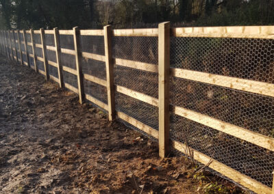 Wood and mesh wire fencing for agriculture
