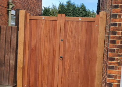 Dark wood side gate for residential property