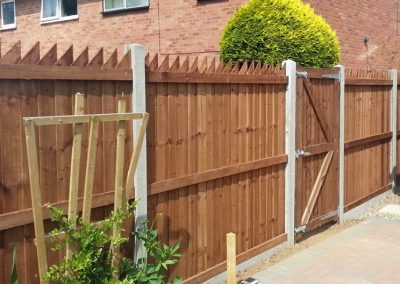 Wooden fencing with concrete supports